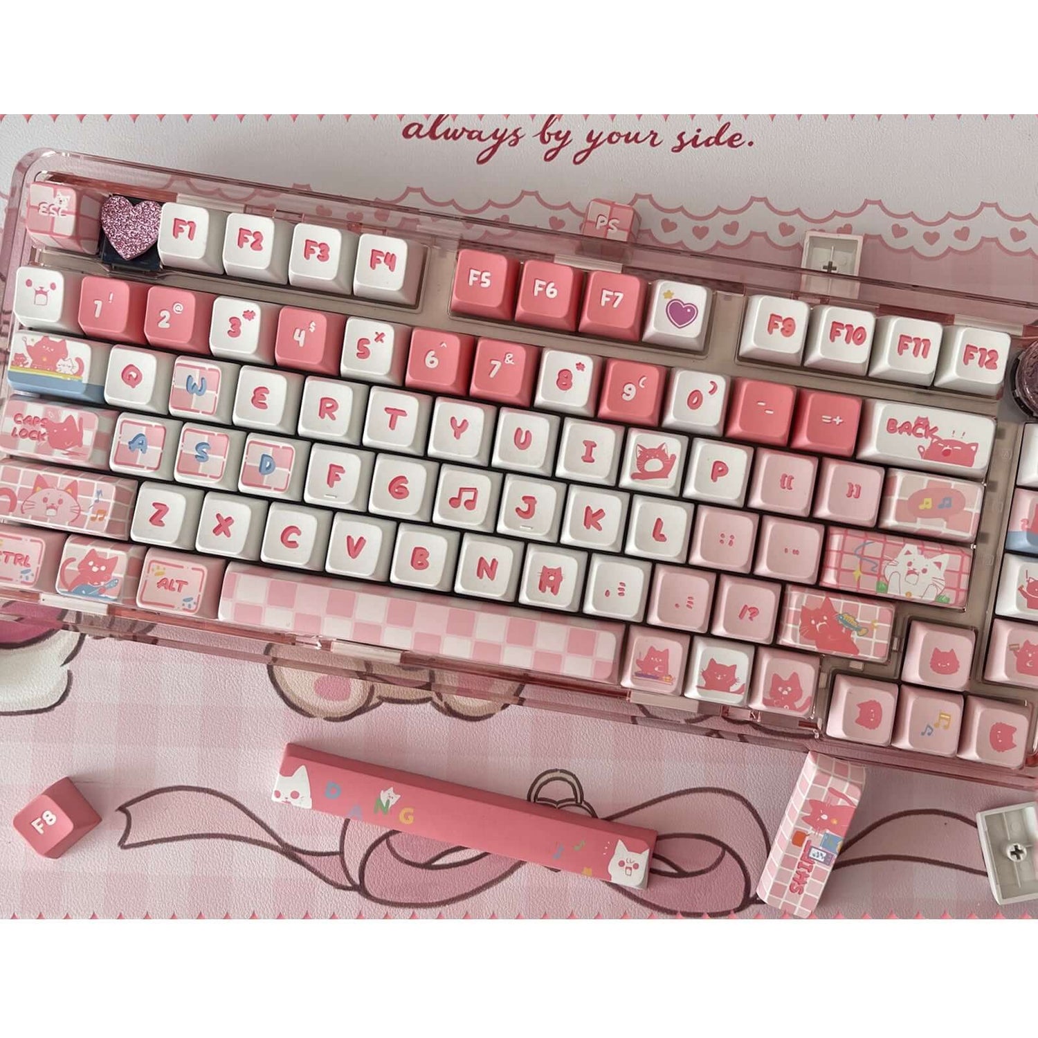 Gamakay 137 Keys Jingle Bell Cat Keycaps Set installed on a mechanical keyboard. The keycaps feature a pink and white color scheme with cute cat-themed illustrations and symbols, designed in the MDA Profile. The set includes additional keycaps suitable fo