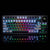 The image displays a Gamakay LK75 mechanical keyboard with a 75% layout, featuring 83 keys and a compact design without a number pad. The keyboard is illuminated by vibrant rainbow-colored backlighting, creating a striking visual effect against the dark b