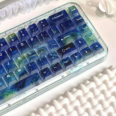 Left-side view of Gamakay Transparent Starry Sky keycaps, showing gradient blue and green tones under natural light